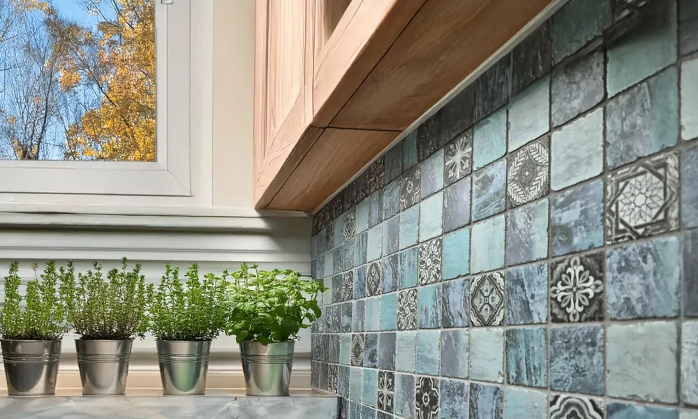 Peeacelily | Color Tiles: How to Bring Color, Pattern, and Plants Together in Your Home Blue mosaic tiles next to small potted herbs on a kitchen counter.