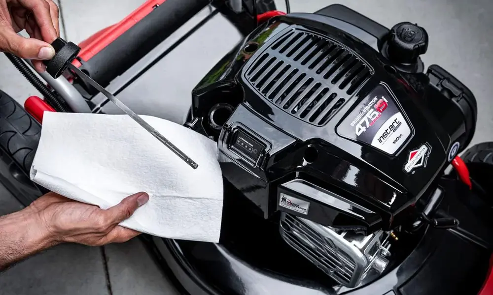 Peeacelily | Lawn Mower Repair: Common Problems and How to Fix Them Checking the engine oil level of a lawn mower using a dipstick and a paper towel.