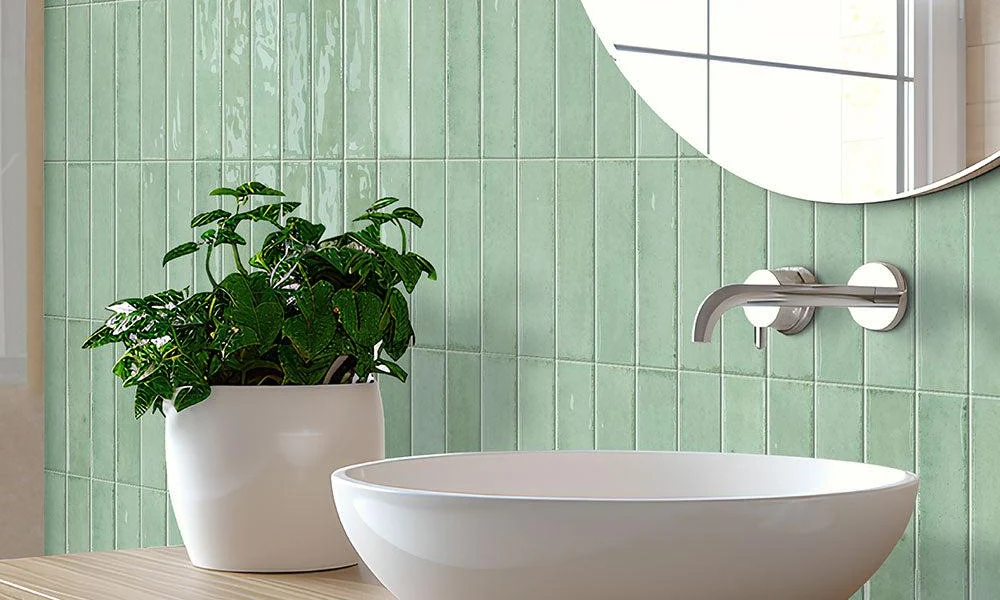 Peeacelily | Color Tiles: How to Bring Color, Pattern, and Plants Together in Your Home Light green vertical tiles in a bathroom next to a sink and potted plant.