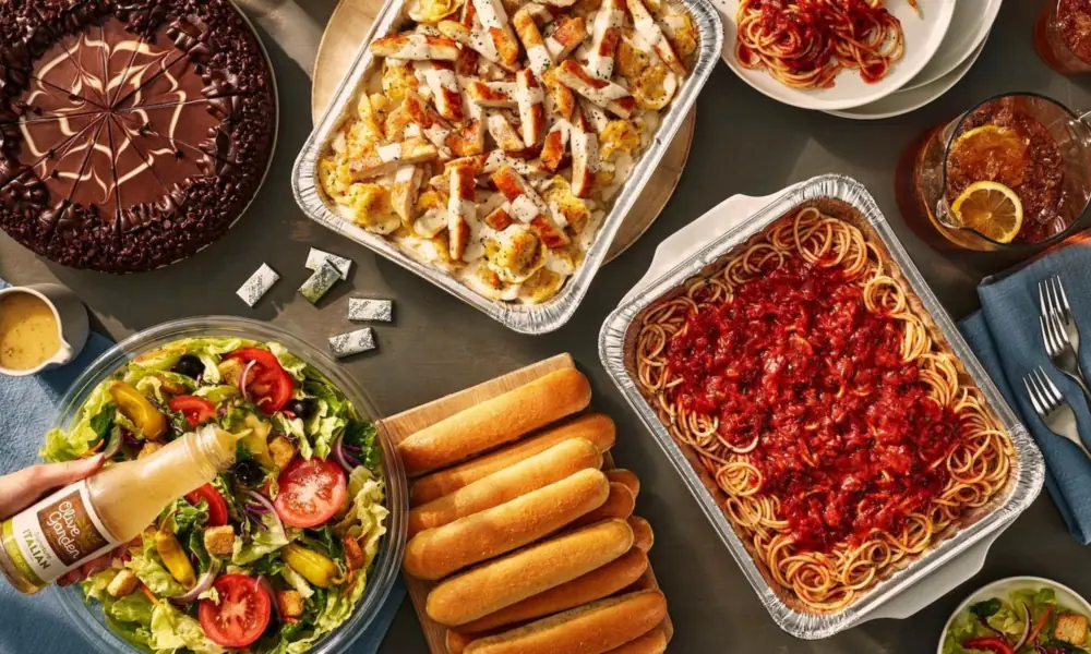 Peeacelily | Olive Garden: A Guide to the Menu, Dining, and Ordering Generous spread of family-style catering trays, salad, chocolate cake, and breadsticks for group savings