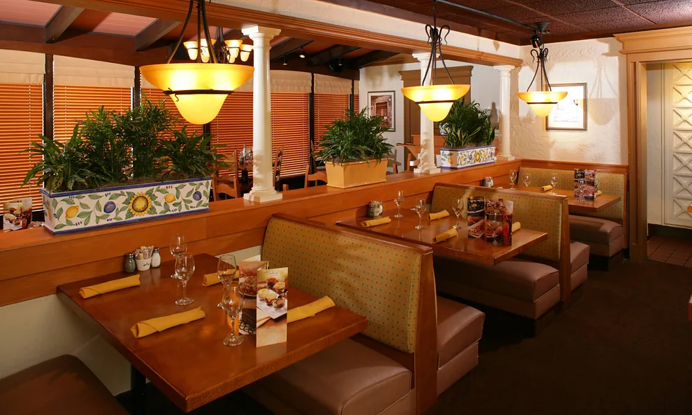 Peeacelily | Olive Garden: A Guide to the Menu, Dining, and Ordering Clean, cozy restaurant booth seating area inside an Olive Garden dining room