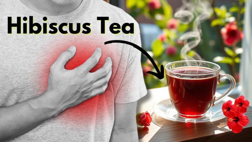 Person holding chest next to a steaming cup of red hibiscus tea.