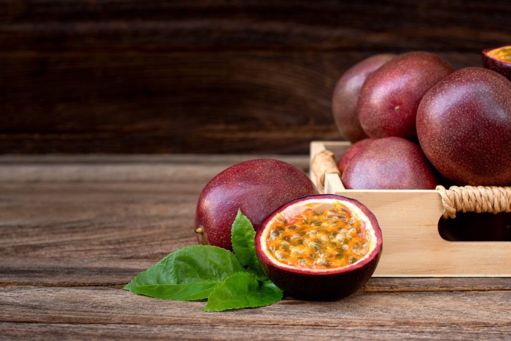 Fresh passion fruit with wooden background in WordPress media library.
