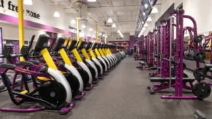 Peeacelily | Planet Fitness: Membership Costs, Equipment, Benefits, and What to Know Clean, modern gym interior featuring rows of treadmills and strength training equipment